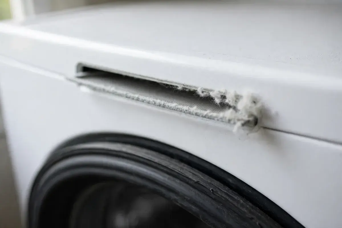 Dryer lint screen slot with a thin layer of lint along the edge